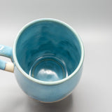 Blue ceramic mug on a light gray background
